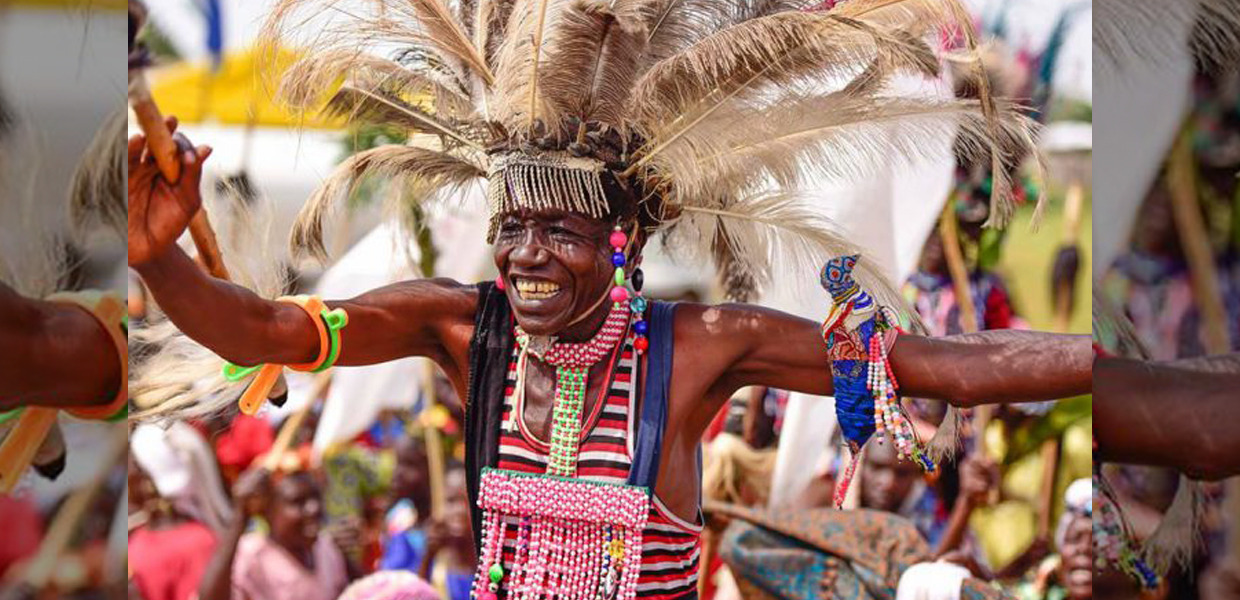 Iteso performer wearing beaded ceremonial dress